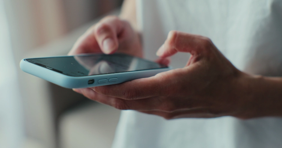 Doctor using mobile scheduling app for patient appointments.